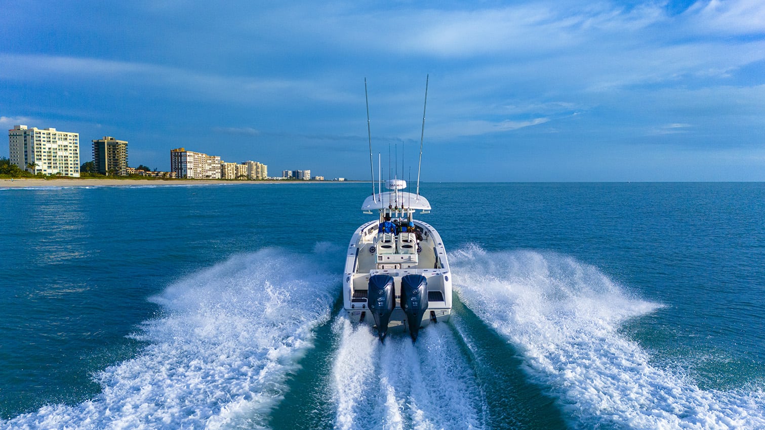 Cobia 265 CC Open boat cruising on water