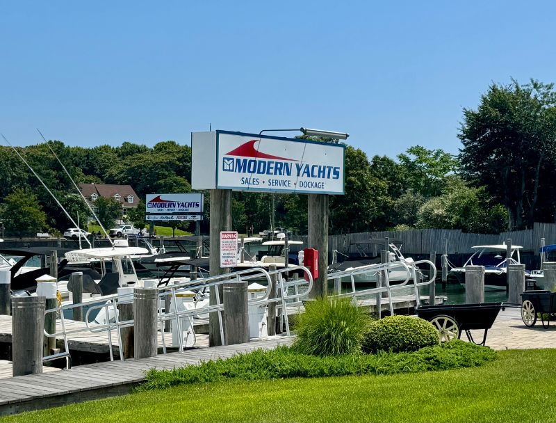 Modern Yachts sign by the docks at Hampton Bays on a sunny day